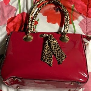 Pink/Red purse with cheetah print.